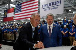 Euisun Chung, Executive Chair, Hyundai Motor Company, left, stands with Georgia Gov. Brian Kemp as Chung signs an IONIQ 9 EV vehicle during a media tour and grand opening at the Hyundai Motor Group Metaplant America, March 26, 2025, in Ellabell, Ga.