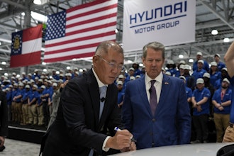 Euisun Chung, Executive Chair, Hyundai Motor Company, left, stands with Georgia Gov. Brian Kemp as Chung signs an IONIQ 9 EV vehicle during a media tour and grand opening at the Hyundai Motor Group Metaplant America, March 26, 2025, in Ellabell, Ga.