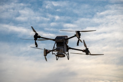 Industrial drone hovering mid-flight.