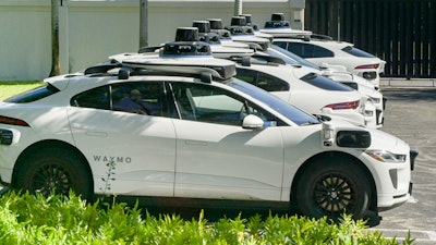 Row of self-hail autonomous driving taxi cabs owned and operated by Waymo.