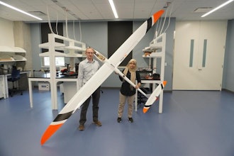 John Bird, Ph.D., and Afroza Shirin, Ph.D., stand with a model aircraft used in their research on soaring.