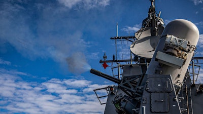 The Arleigh Burke-class guided-missile destroyer USS Rafael Peralta (DDG 115) fires a Phalanx Close-In Weapons System (CIWS) during a live fire exercise.