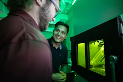 Mechanical engineering master’s students Reese Rodely (left) and Kamal Kunwar discuss what they are observing in SIU Carbondale’s 3D metal printer.