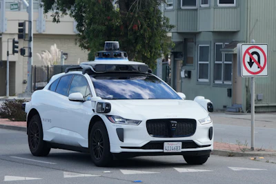 A Waymo vehicle drives past a No U-Turn sign in San Bruno, Calif., Tuesday, Sept. 30, 2025.