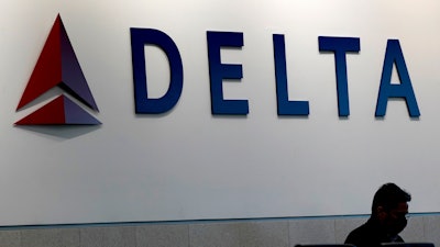 A man waits for a Delta Airlines flight at Hartsfield-Jackson International Airport in Atlanta on Jan. 7, 2022. ()