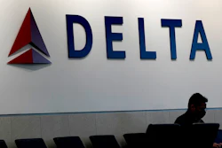 A man waits for a Delta Airlines flight at Hartsfield-Jackson International Airport in Atlanta on Jan. 7, 2022. ()