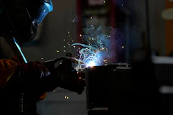 A man works at MAP, a factory operating in design, manufacture and installation of steel structures for civil and industrial use, in Corsico, Italy, May 12, 2022.