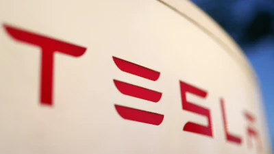 The logo for the Tesla Supercharger station is seen in Buford, Ga, April 22, 2021.
