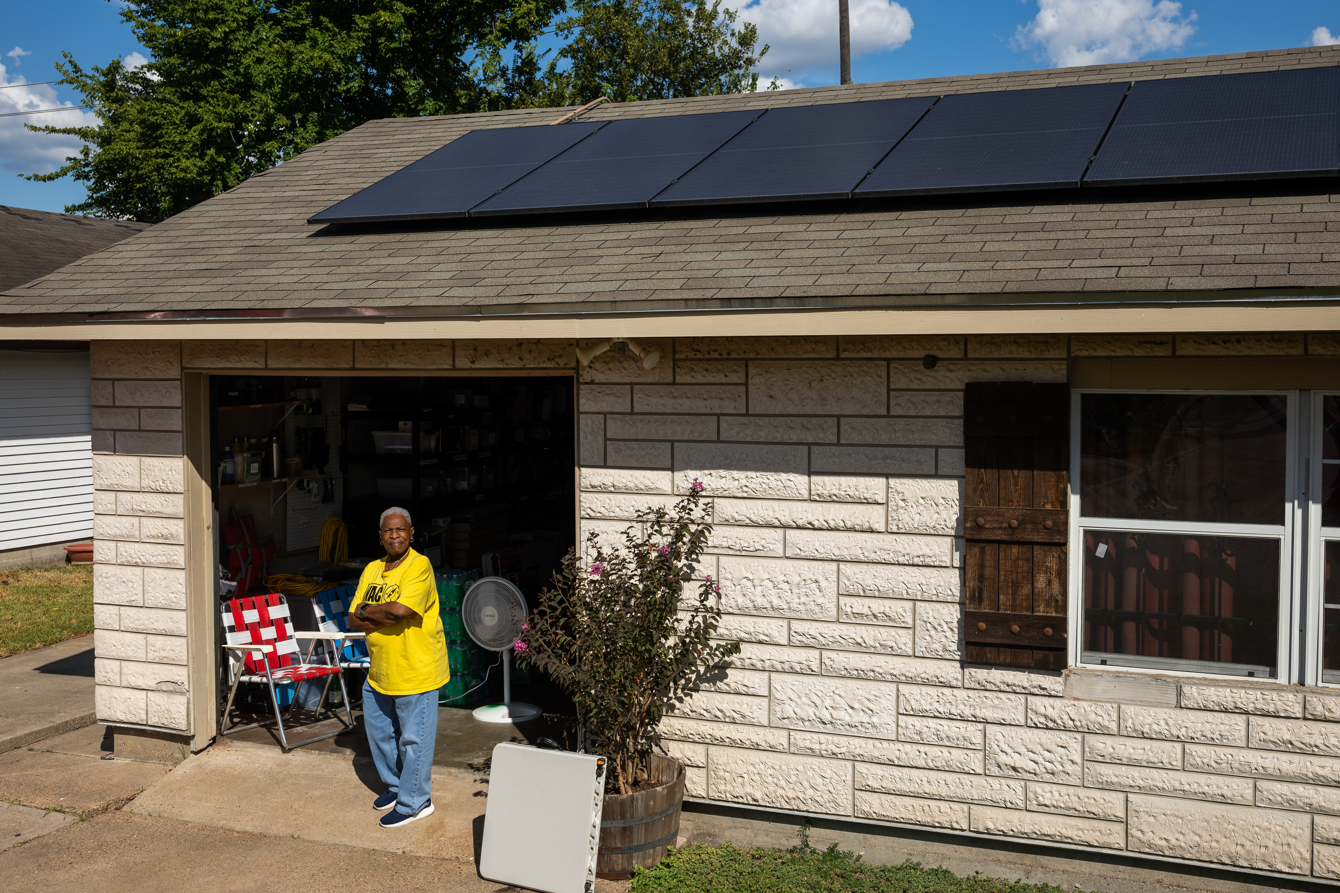 Doris Brown, Hub home captain, poses for a portrait under her solar panels on Wednesday, Oct. 8, 2025, in Houston.