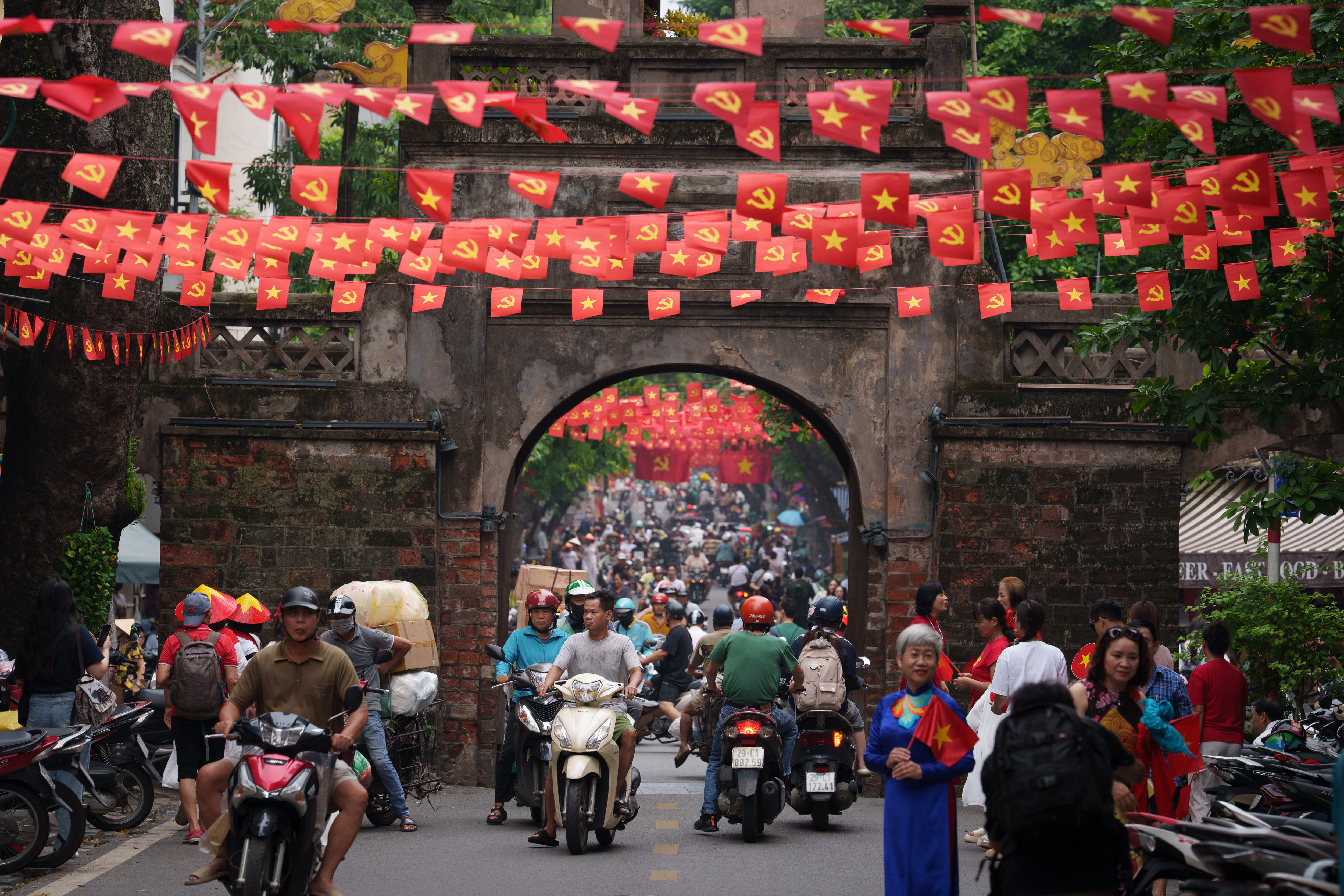 Vietnamese ride two-wheelers in the Old Quarter area in Hanoi, Vietnam, on Sept. 1, 2025.