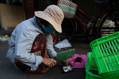An e-waste collector uses a cleaver to remove copper wire from a device in Nhat Tao market, the largest informal recycling market in Ho Chi Minh City, Vietnam, Jan. 31, 2024.
