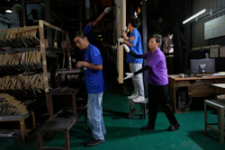 Workers check aluminum panels produced at a factory of Kam Pin Industrial (HK) Ltd, in Dongguan city in southern China's Guangdong province April 17, 2025.