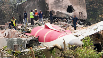 Officials inspect the site of Air India plane crash on the roof of a building in Ahmedabad, India, June 13, 2025.