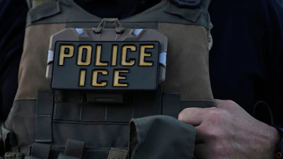 A U.S. Immigration and Customs Enforcement agent takes part in an early morning operation in Park Ridge, Ill., Sept. 19, 2025.