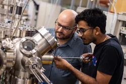 Dr. Rafik Addou (left), assistant professor of materials science and engineering, and Joslin Prasanna, a materials science and engineering graduate student, use an ultrahigh vacuum surface science system, which includes sealed chambers, to process and study materials as part of a project to develop a coating to protect spacecraft in low Earth orbit.