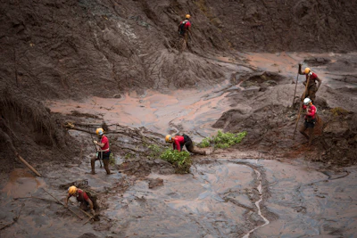 Rescue workers search for victims after a dam burst in the town of Bento Rodrigues in Minas Gerais state, Brazil, Nov. 8, 2015.