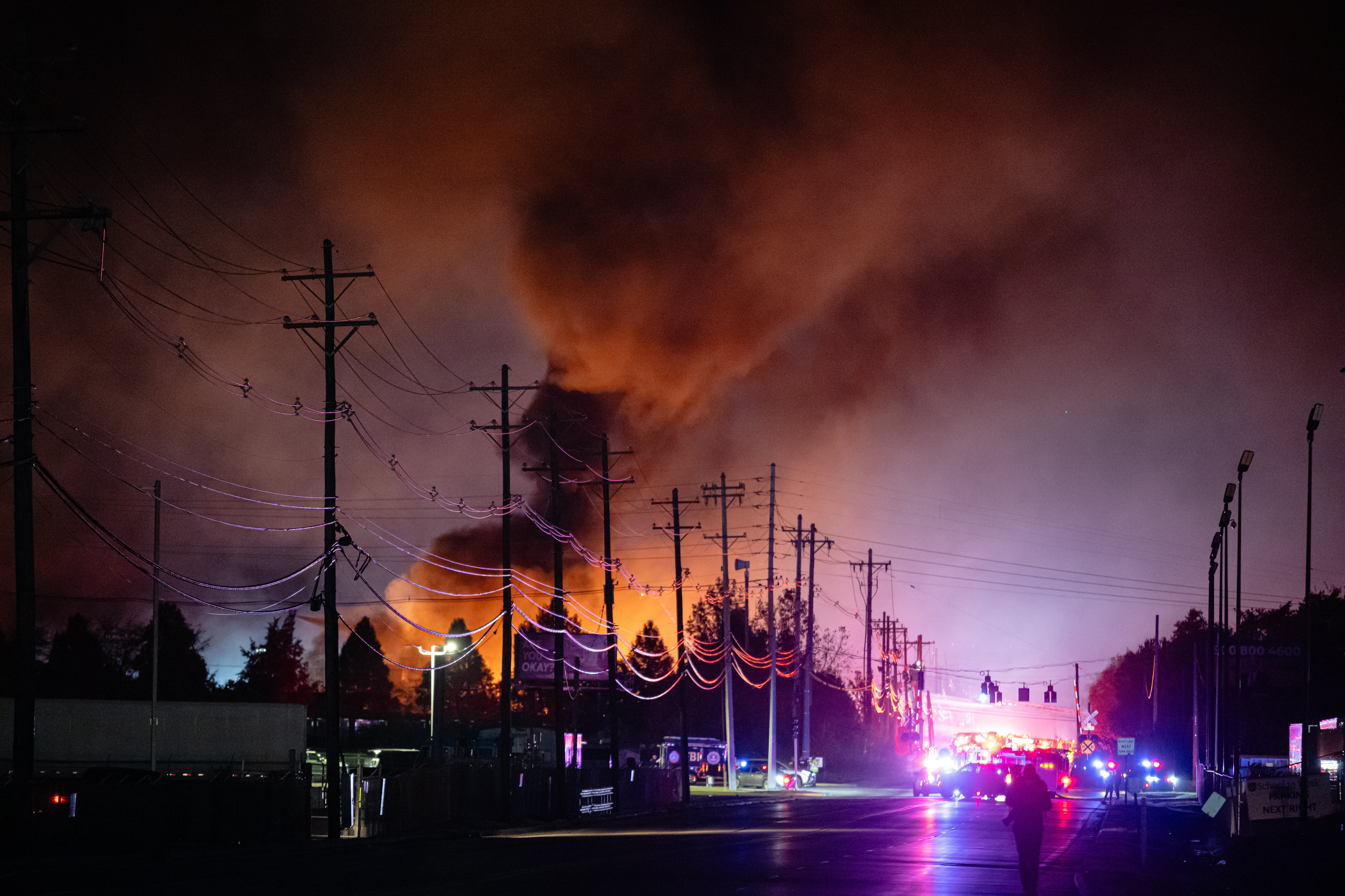 Plumes of smoke rise from the area of a UPS cargo plane crash at Louisville Muhammad Ali International Airport, Louisville, Ky., Nov. 4, 2025.