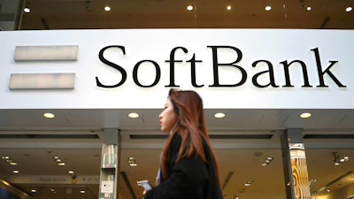 A woman walks in front of SoftBank store in Ginza shopping district in Tokyo, Jan. 20, 2020.