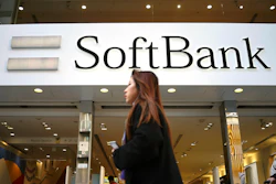 A woman walks in front of SoftBank store in Ginza shopping district in Tokyo, Jan. 20, 2020.
