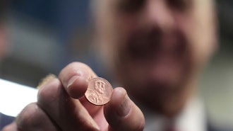 U.S. Treasurer Brandon Beach holds one of the last pennies pressed at the U.S. Mint in Philadelphia, Wednesday, Nov. 12, 2025.