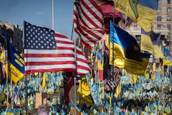 US and Ukrainian national flags wave to commemorate American volunteers, who were killed in battles with Russian troops defending Ukraine, their names are on flags, at the improvised war memorial in Independence square in Kyiv, Ukraine, Sept. 27, 2024.