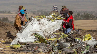 In this March 11, 2019, file photo, rescuers work at the scene of an Ethiopian Airlines flight crash near Bishoftu, Ethiopia. Pilot Bernd Kai von Hoesslin pleaded with his bosses for more training on the Boeing Max, just weeks before the Ethiopian Airline's jet crashed, killing everyone on board.