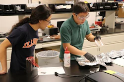 Aerospace undergrad Alex Kuehnle observes PhD student Ivan Wu in the composites laboratory at the University of Illinois Urbana-Champaign.