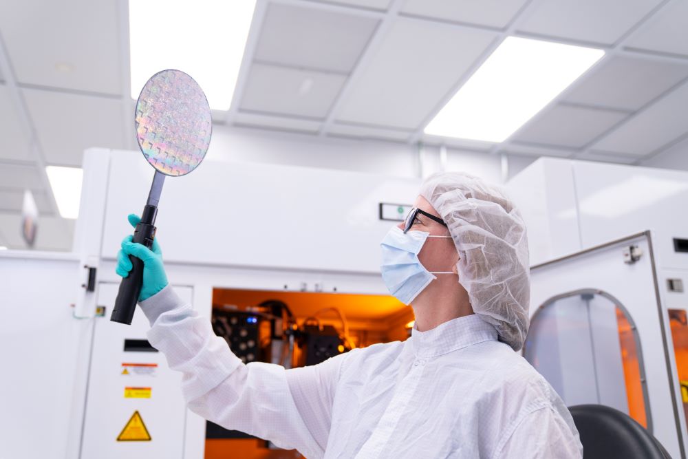 A Northrop Grumman engineer inspects a microelectronics wafer at the Central Florida manufacturing and advanced packaging facility.