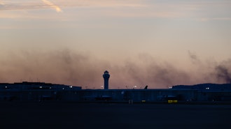 The ATC tower is seen while smoke rises from the crash site of UPS Flight 2976 near Louisville Muhammad Ali International Airport on Wednesday, Nov. 5, 2025, in Louisville, Ky.