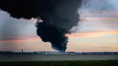 A plume of smoke rises from the site of a UPS cargo plane crash at Louisville Muhammad Ali International Airport on Tuesday, Nov. 4, 2025, in Louisville, Ky.