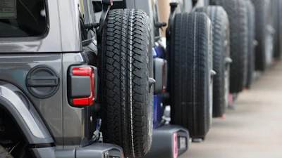 Spare tires are seen on a long row of unsold 2020 Wranglers sit at a Jeep dealership in Englewood, Colo., on April 26, 2020.