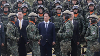 Taiwan's President Lai Ching-te, center, waits for a group photo with soldiers during the inauguration ceremony of M1A2T Abrams Main Battle Tanks in Hsinchu County, Taiwan, Friday, Oct. 31, 2025.