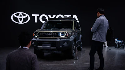 Members of the media and guests look at Toyota's Corolla concept during the press day of the Japan Mobility Show, in Tokyo, Thursday, Oct. 30, 2025.