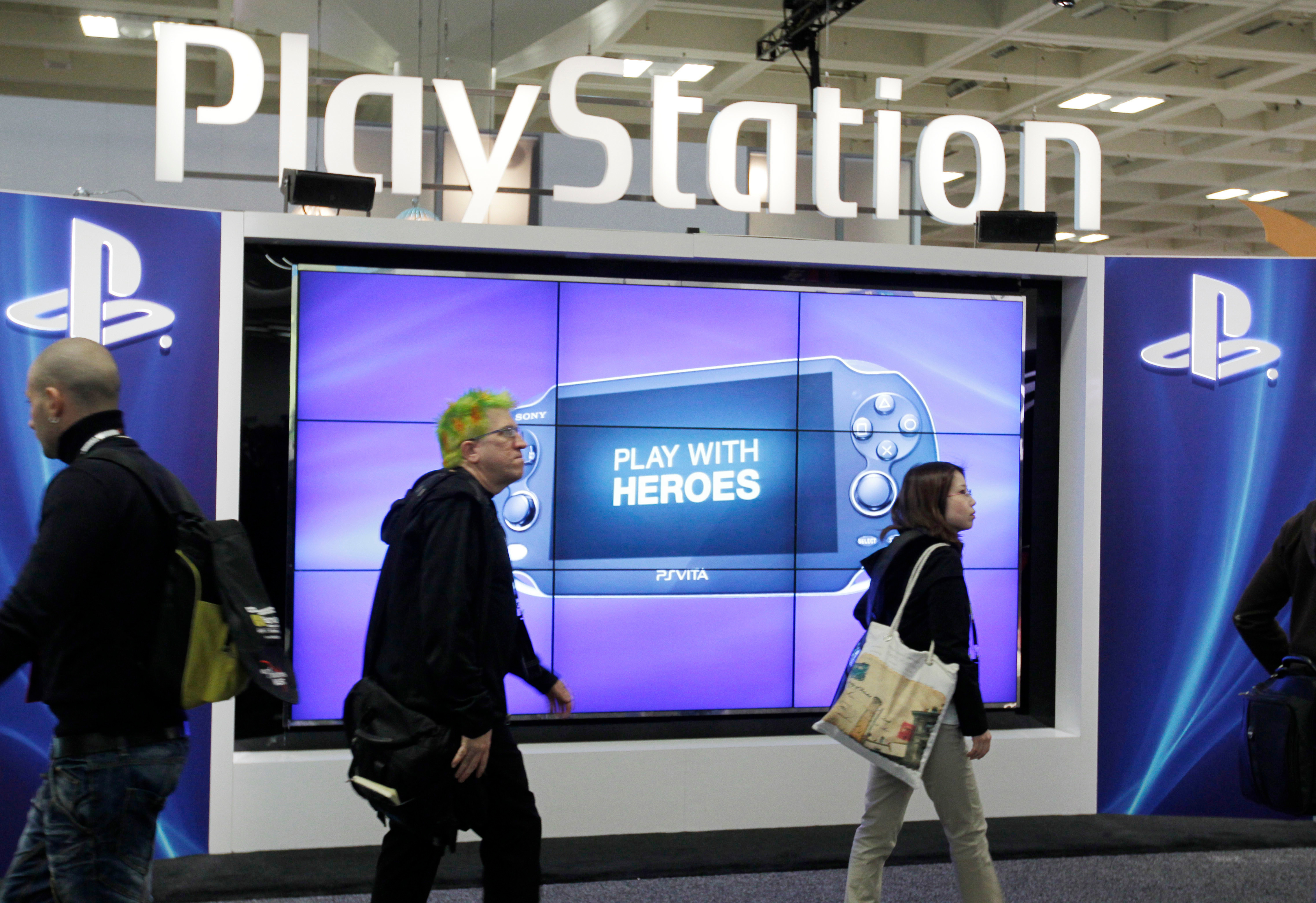 Attendees walking past the Sony PlayStation PS Vita console on display in the Sony PlayStation booth at the Game Developers Conference in San Francisco on March 8, 2012.