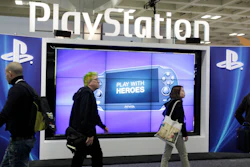 Attendees walking past the Sony PlayStation PS Vita console on display in the Sony PlayStation booth at the Game Developers Conference in San Francisco on March 8, 2012.
