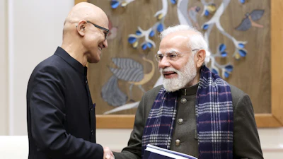 In this handout photo provided by Microsoft, Chief Executive Officer Satya Nadella, left, shakes hands with Indian Prime Minister Narendra Modi during their meeting in New Delhi, India, Tuesday, Dec. 9, 2025.