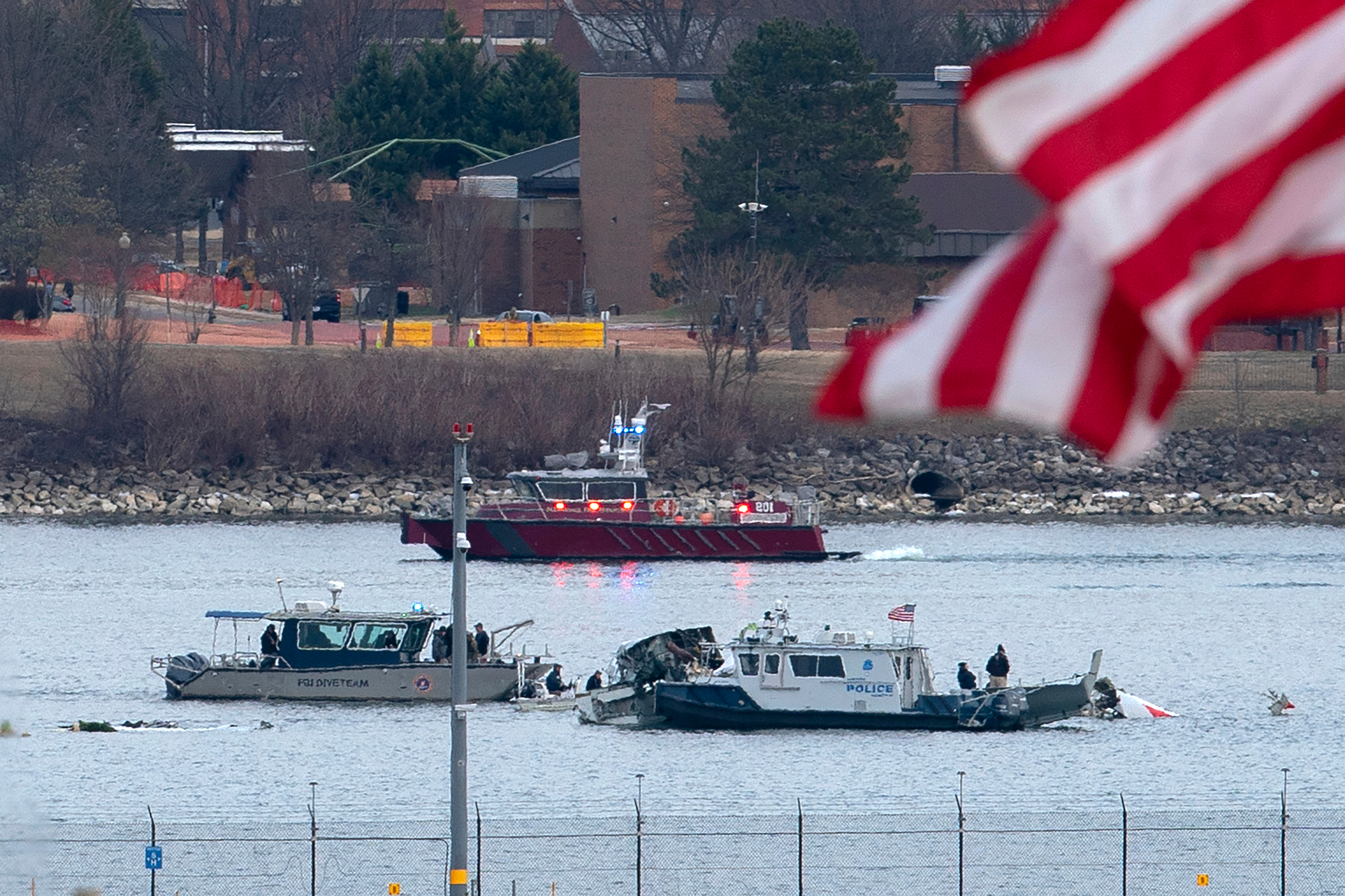 A diving team and police boat is seen near a wreckage site in the Potomac River, from Ronald Reagan Washington National Airport, Jan. 30, 2025, in Arlington, Va.