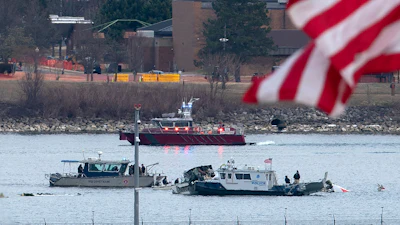 A diving team and police boat is seen near a wreckage site in the Potomac River, from Ronald Reagan Washington National Airport, Jan. 30, 2025, in Arlington, Va.
