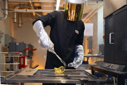 Nicholas Clark, a postdoctoral fellow at Penn State and one of the inventors of LionGlass, molds a piece of glass after removing it from a forge in the team's research lab.
