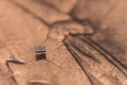 A microrobot on a U.S. penny, showing scale.