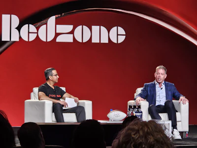 QAD | Redzone CEO Sanjay Brahmawar (left) interviews former NFL quarterback Troy Aikman at Champions of Manufacturing in Dallas, Texas.