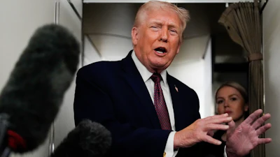 President Donald Trump speaks to reporters while in flight on Air Force One to Joint Base Andrews, Md., Sunday, Jan. 11, 2026.