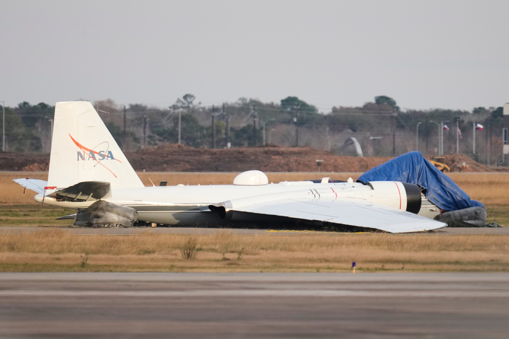 A NASA aircraft sits near a runway at Ellington Airport after making a belly landing on Tuesday, Jan. 27, 2026, in Houston.
