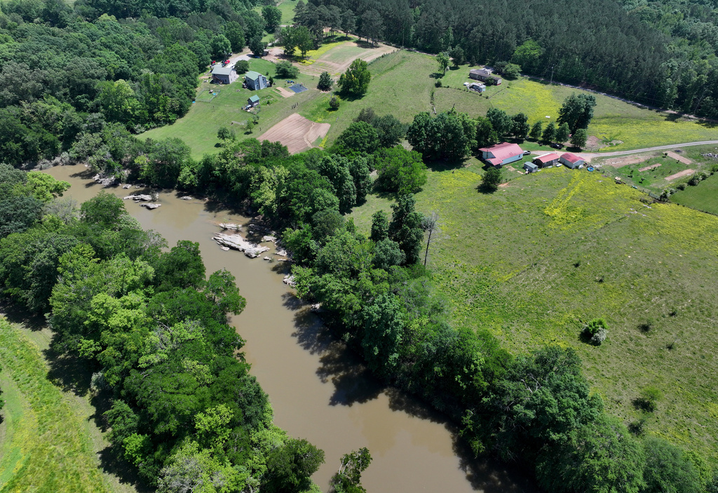 Faye Jackson has lived for decades on a patch of rural land, right, in Resaca, Ga., on the banks of the Conasauga River, seen on Thursday, May 8, 2025.