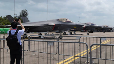 A man takes a picture of a row of F-35 Lightning II fighter jets during the Singapore Air Show on Thursday, Feb. 5, 2026.