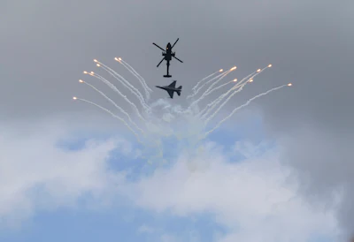 An AH-64 Apache helicopter and an F-16 fighter jet with the Singapore Armed Forces display their skills during the Singapore Air Show on Thursday, Feb. 5, 2026.