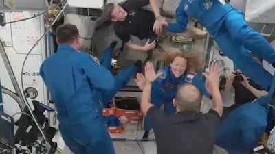 In this image from video provided by NASA, France’s Sophie Adenot, Russia’s Andrei Fedyaev and Americans Jessica Meir and Jack Hathaway greet colleagues as they enter the International Space Station after arriving on a SpaceX Dragon capsule on Saturday, Feb. 14, 2026.