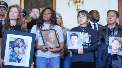 Family members of the people who were killed in the midair collision near Washington Reagan National Airport listen during a news conference as Rep. Don Beyer, D-Va., speaks, not shown, on Capitol Hill, Tuesday, Feb. 24, 2026, in Washington.