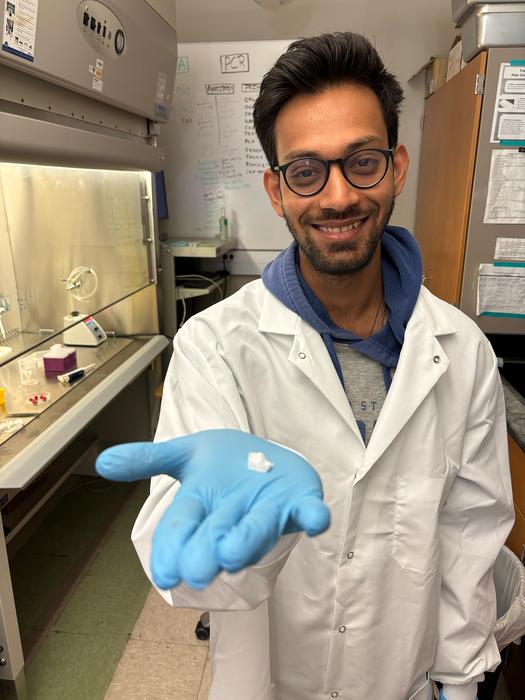 Texas A&M University biomedical engineering doctoral student and researcher Saptarshi Biswas holds a sample of the hemostatic dressing.