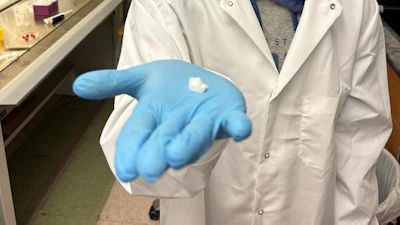 Texas A&M University biomedical engineering doctoral student and researcher Saptarshi Biswas holds a sample of the hemostatic dressing.
